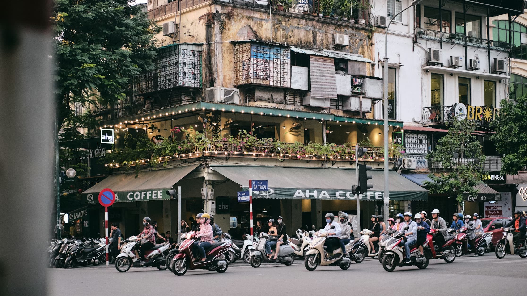 Motorbikes and scooters on a busy Ho Chi Minh City street at night
