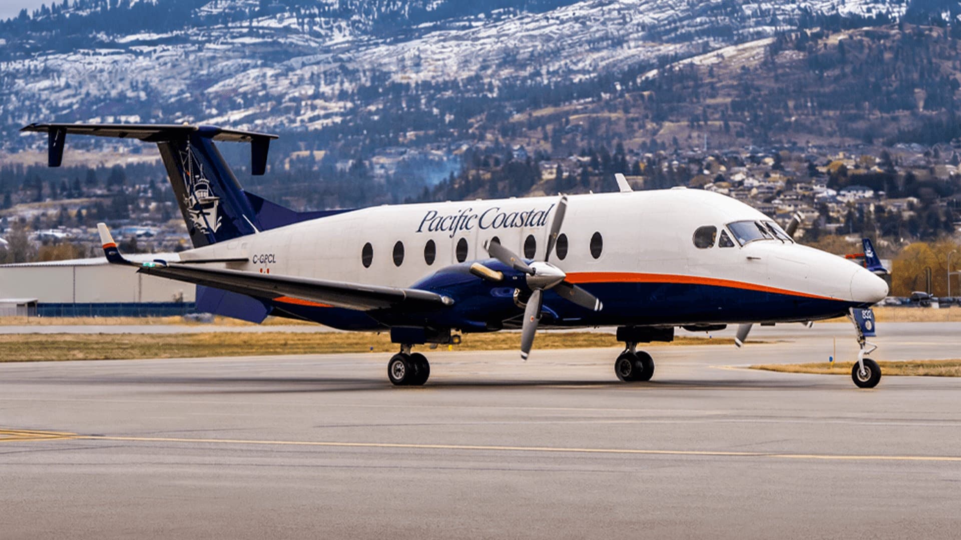 Pacific Coastal Airlines Beechcraft 1900 taxiing with mountains behind