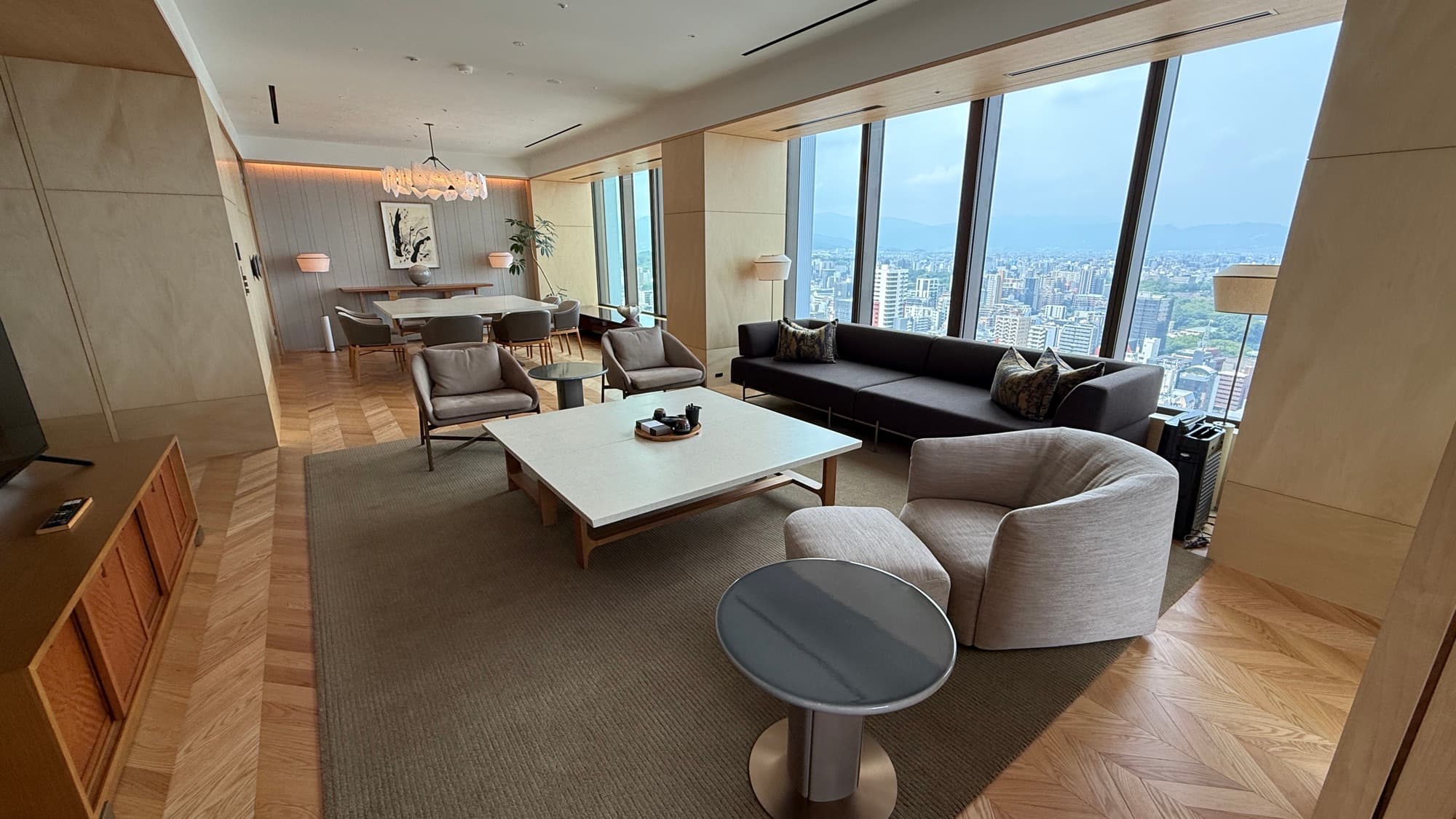 Living room of the Ritz-Carlton Suite with city views and a long sofa