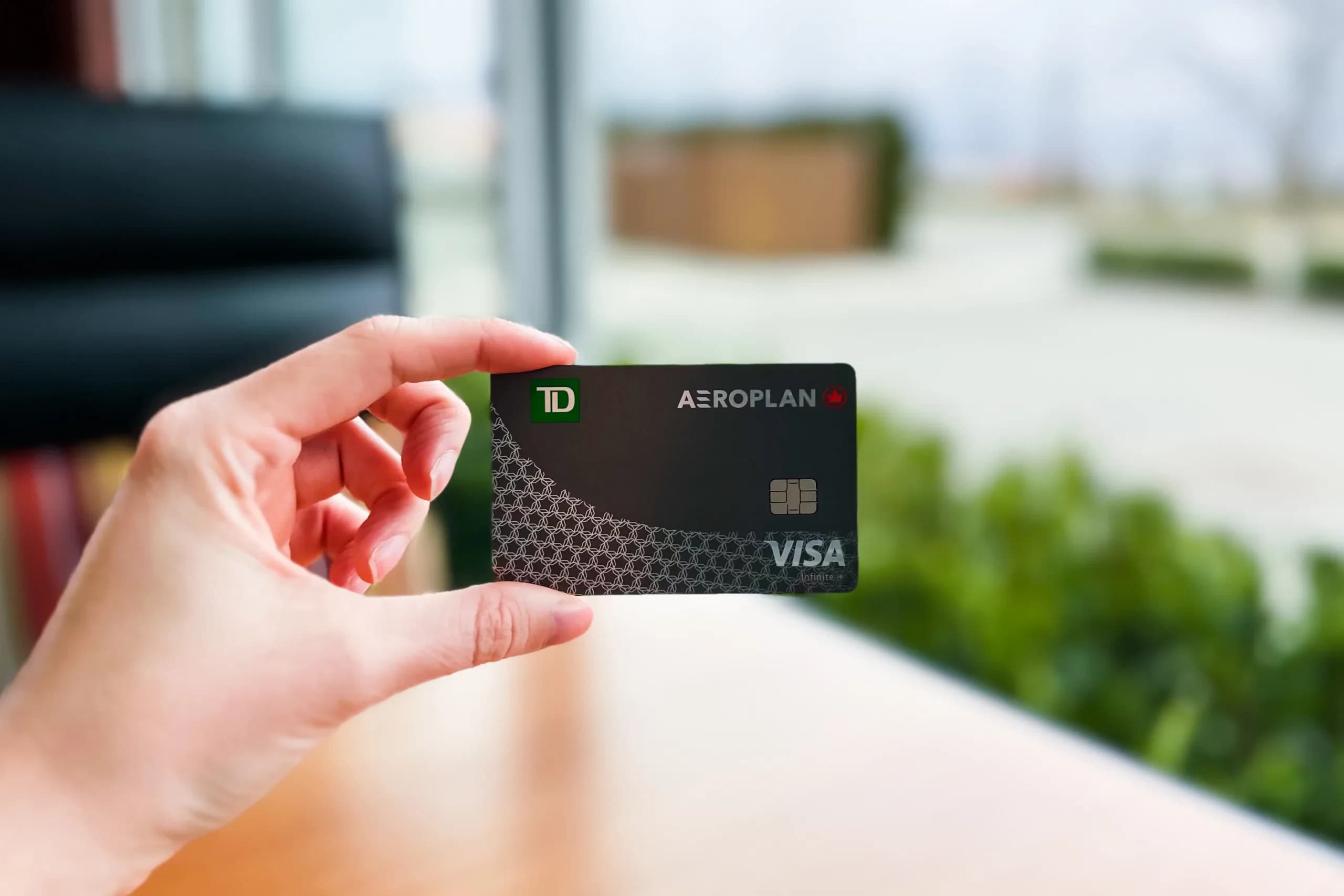 Hand holding the TD Aeroplan Visa Infinite+ card