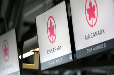 FILE - This May 16, 2020 file photo shows Air Canada check screens at Ottawa International Airport in Ottawa, Ontario, Canada.   The U.S. government is seeking to fine Air Canada more than $25 million over what it says have been slow refunds for passengers whose flights were canceled since the pandemic started. The Transportation Department said Tuesday, June 15, 2021,  it has received more than 6,000 consumer complaints about Air Canada since March of last year. (Justin Tang/The Canadian Press via AP)